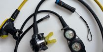 A Dive Light And Dive Regulator Scattered On A Table