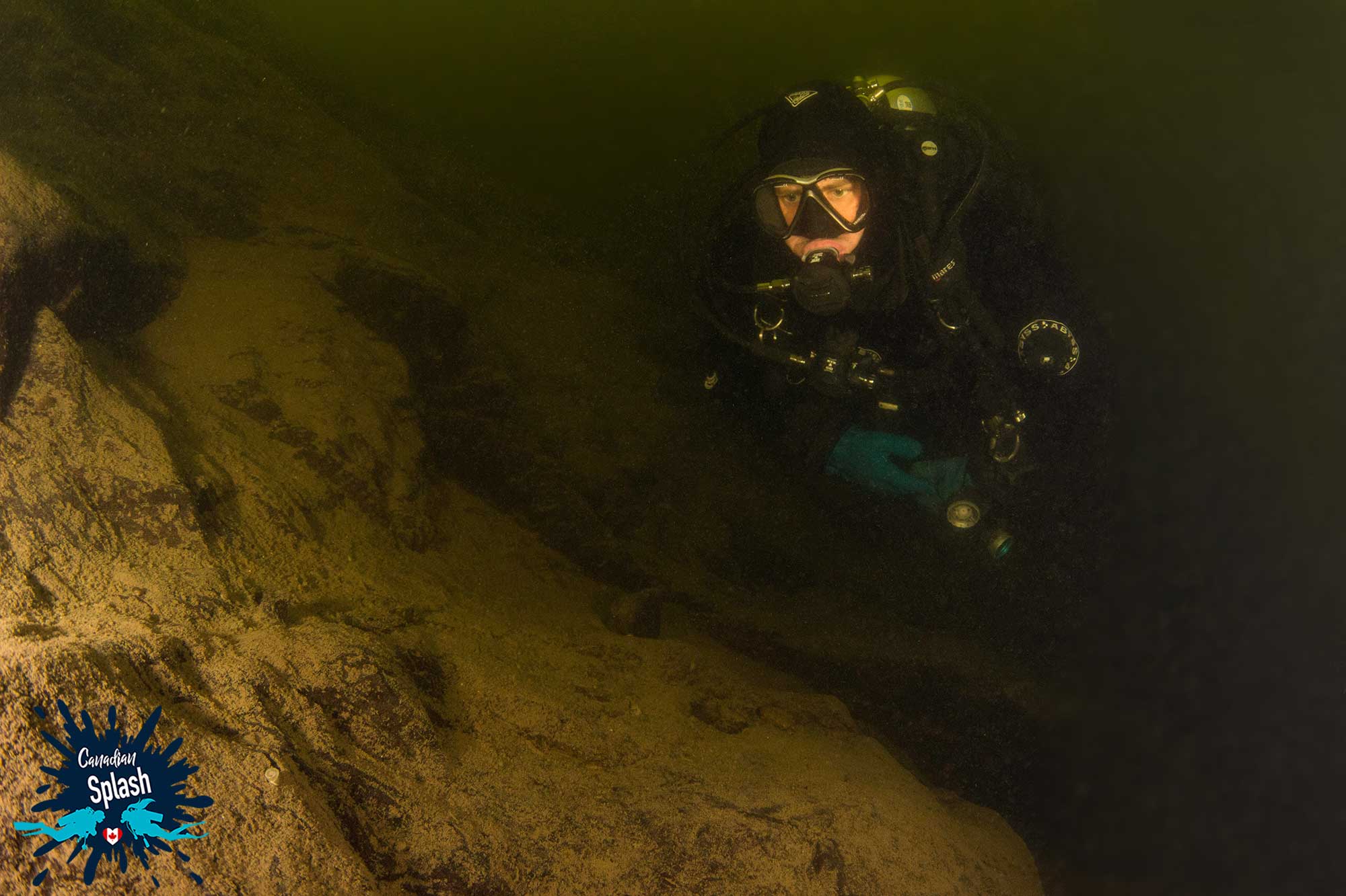 A Scuba Diver Underwater Along The Rocky Wall Of The Meteor Impact West Hawk Lake In Manitoba, Scuba Diving Canada