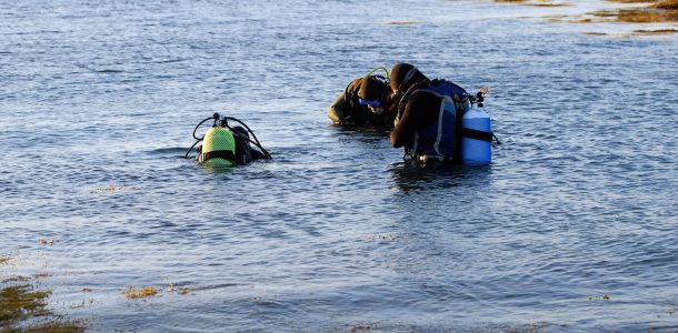 A Trio Of Scuba Divers In The Cold Water Close To Halifax, Nova Scotia In Canada