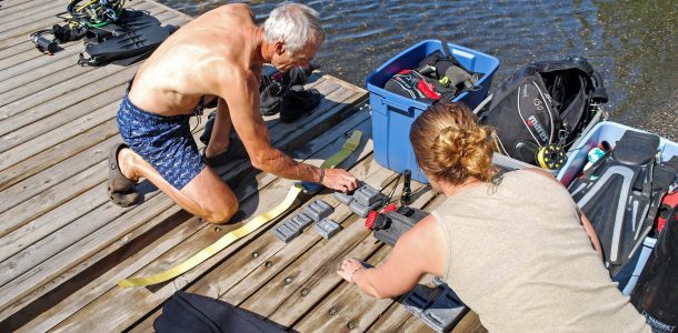 Alisha And Andy Preparing Scuba Diving Equipment Before Heading Into The Water In Temagami, Ontario, Canada