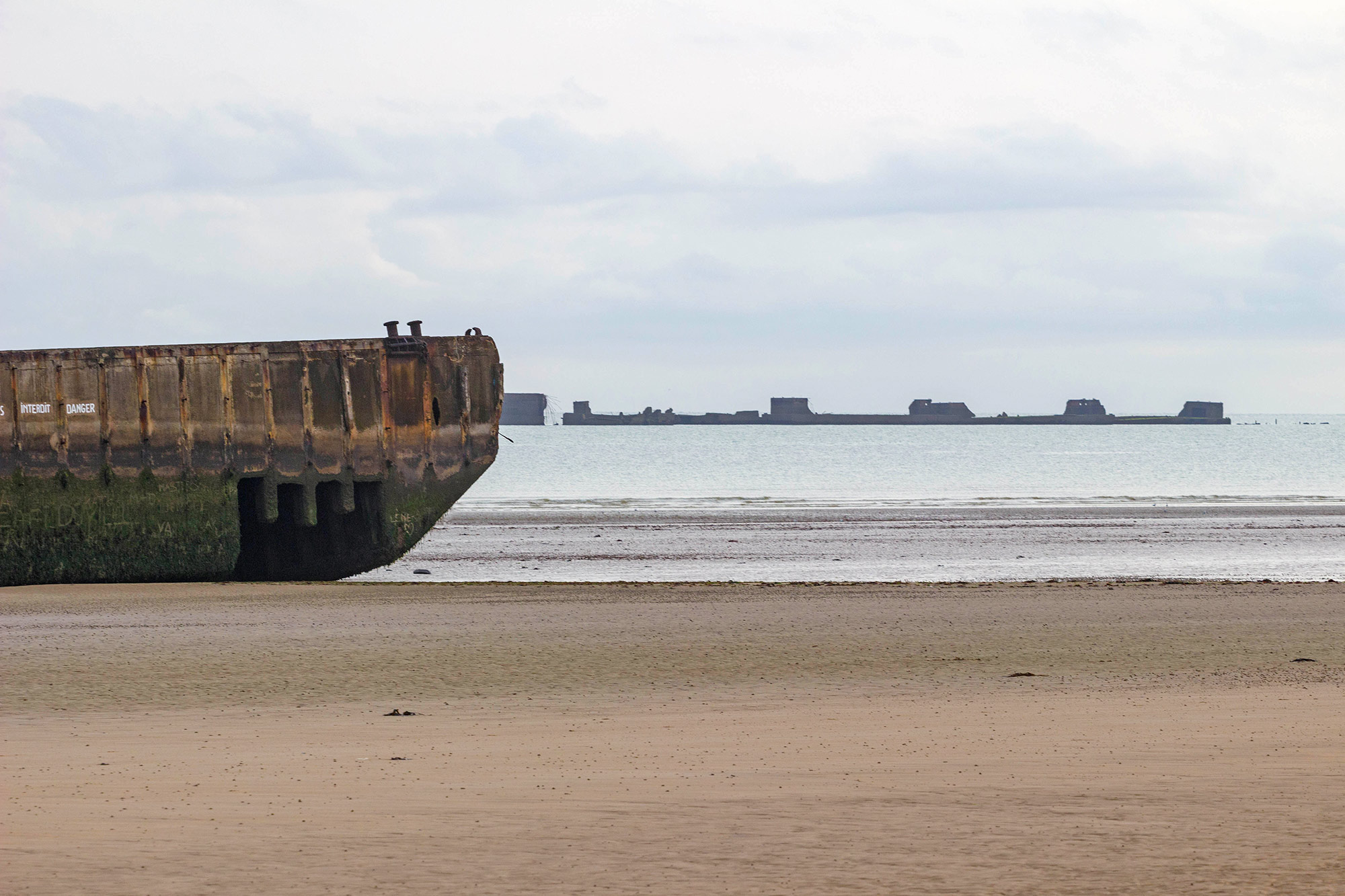 D-Day Landing Beach View With The Leftover Floating Pontoons, Normandy, France