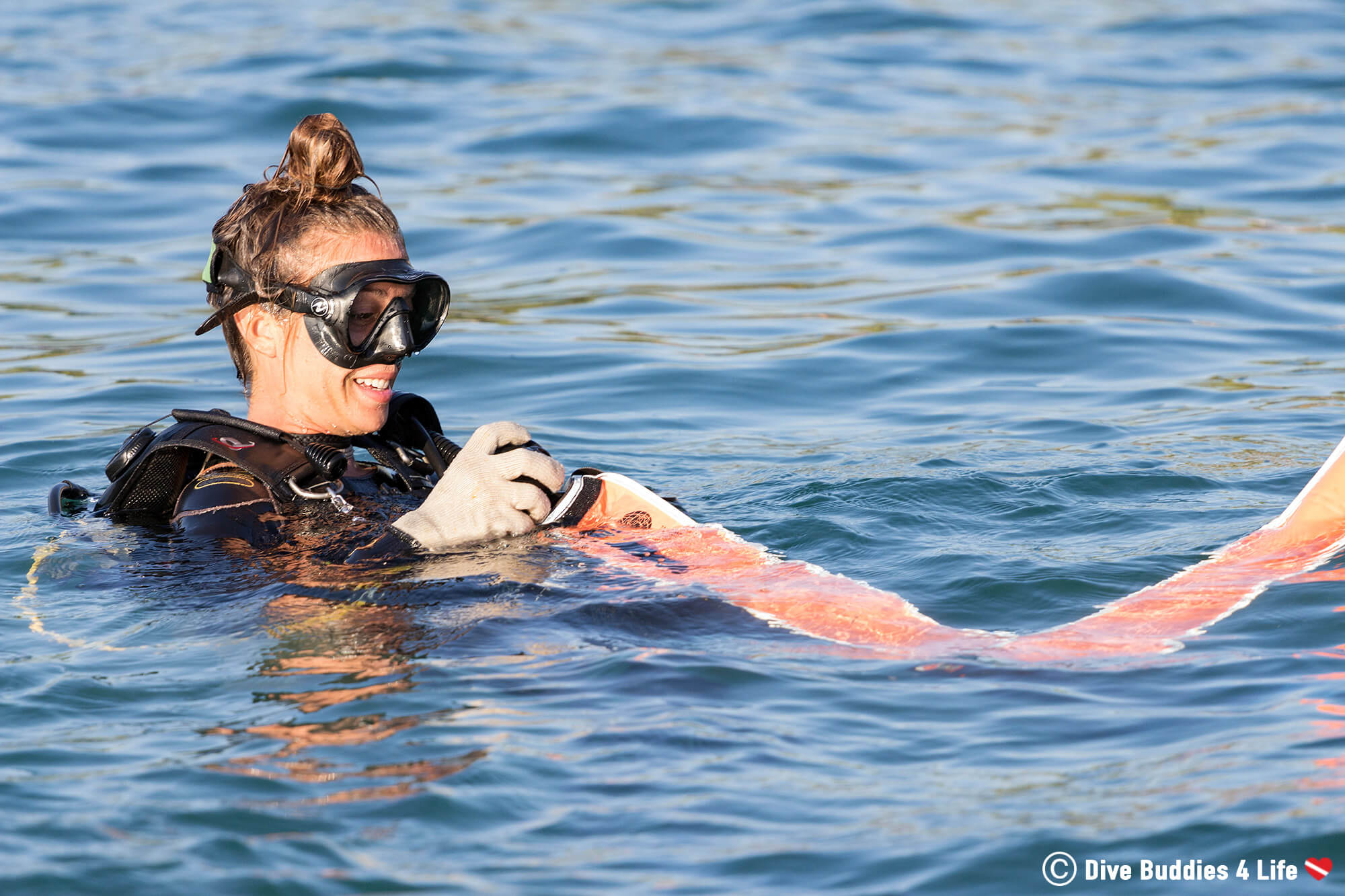 Female Scuba Diver Rolling Up Her Safety Buoy After A Dive In Zihua, Mexico