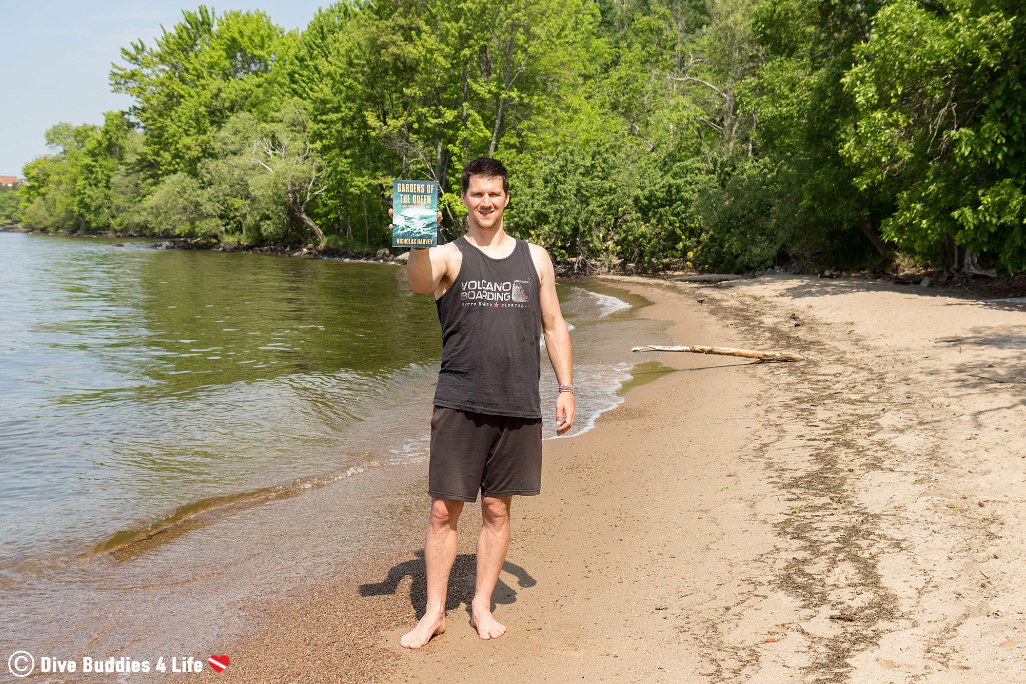 Joey Holding The Gardens Of The Queen AJ Bailey Scuba Diving Novel On The Sandy Beach Of North Bay