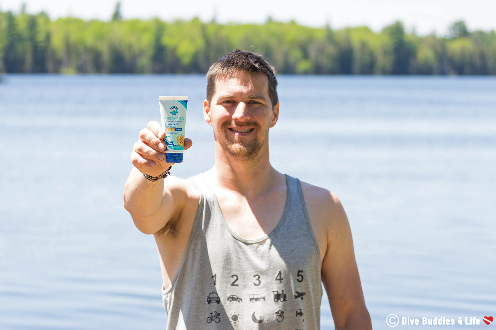 Joey Showcasing A Stream2Sea Tube Of Sunscreen Near The Water, Ontario