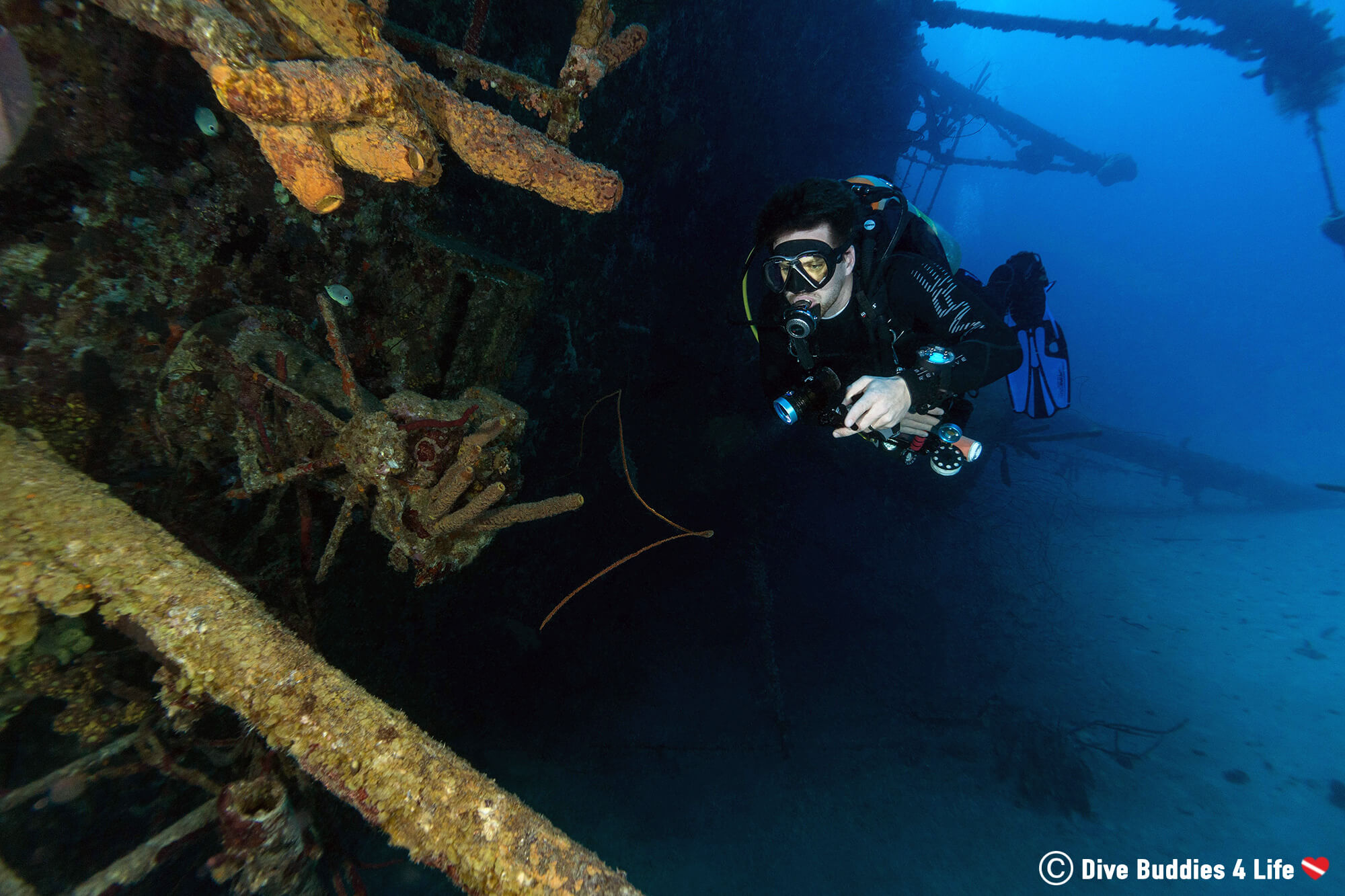 Joey Using His Flashlight And Diving The Hilma Hooker Shipwreck On The South Of Bonaire, Dutch Caribbean