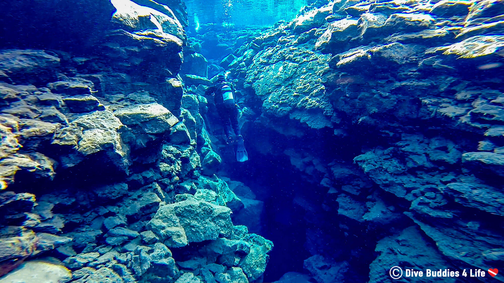Scuba Diver Between The Rocks Of The Silfra Fissure In Iceland, Europe