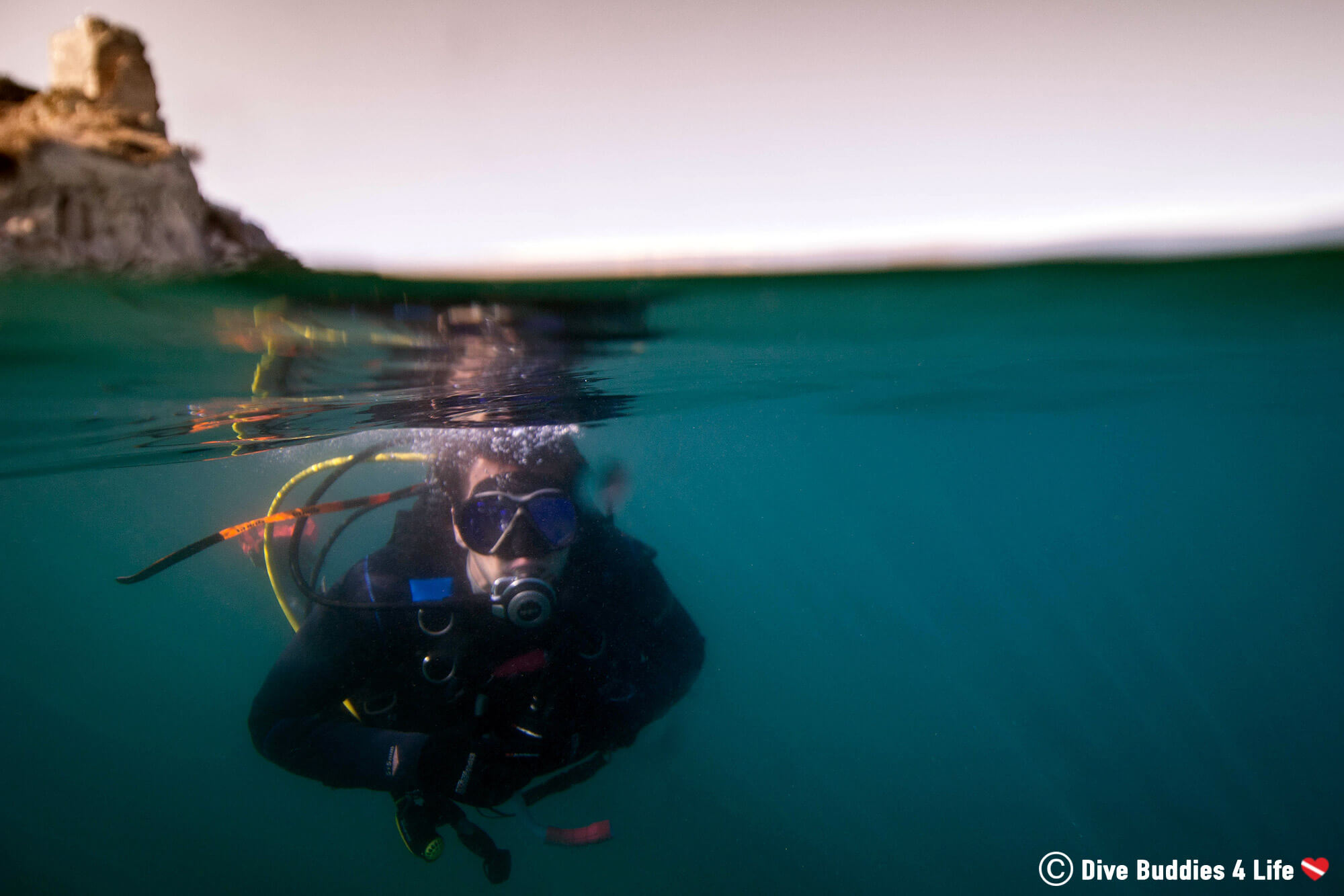 Split Underwater Photograph Of Joey Diving The Underwater Archeological Park Of Baiae And Getting His Dive Equipment Salty in Naples, Italy, Europe