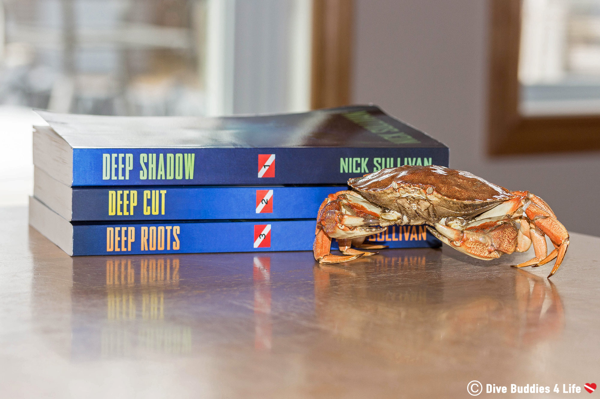 The Deep Series Scuba Diving Books And A Crab Displayed On A Table