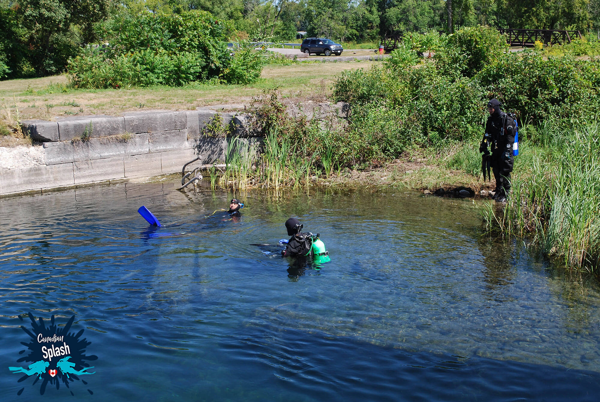 Three Scuba Divers At The Entry Point To The Gallo Canal WeeHawk Wreck In Southern Ontario, Canada Scuba Diving