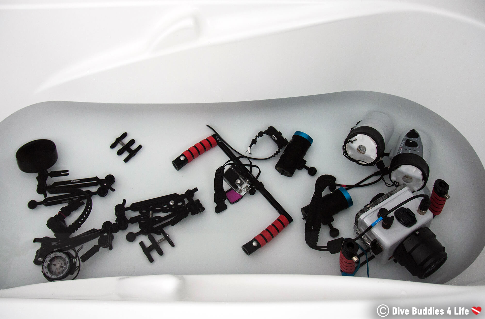 Underwater Camera And GoPro Gear Getting Cleaned In The Bath Tub After A Scuba Dive